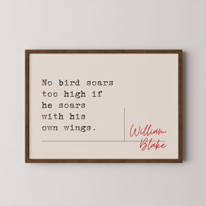 May include: A framed print with a beige background and a black typewriter font quote that reads "No bird soars too high if he soars with his own wings." The quote is attributed to William Blake in red cursive handwriting.