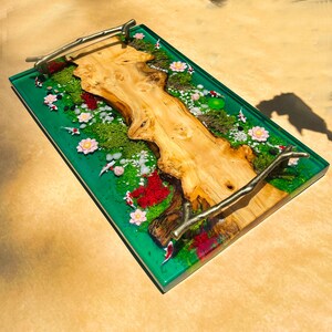 May include: A rectangular serving tray with a vibrant green resin base. The tray features a natural wood centerpiece, miniature koi fish, and floral accents. The tray has metal branch handles.