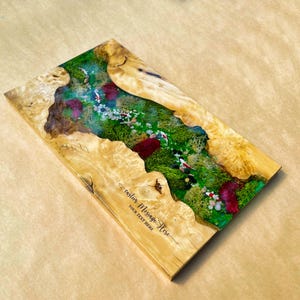 May include: Wooden rectangular art piece with a river scene. The river features green moss, colorful fish, and stones. The edges are made of light-colored wood. Text on the wood reads "custom Message Here" and "YOUR TEXT HERE".