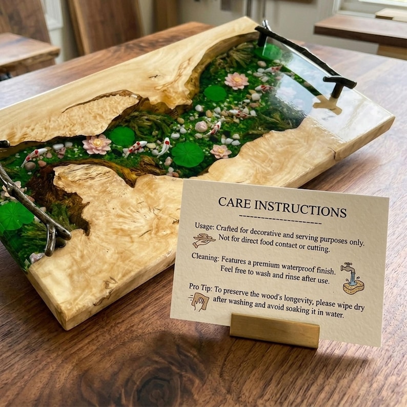 May include: A rectangular wooden serving tray with a river scene of koi fish, lily pads, and flowers encased in clear resin. The tray has a light wood border and a small card with care instructions.
