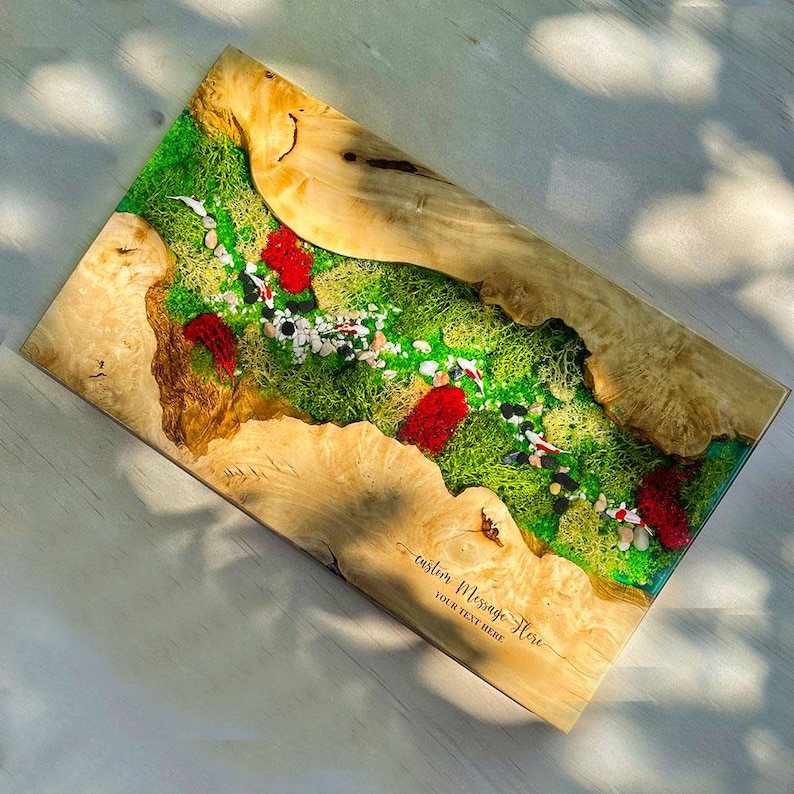 May include: A rectangular wooden resin art piece featuring a vibrant green moss landscape with red accents and small white stones. The edges are natural wood, and the piece includes the text "custom MESSAGE Here" and "YOUR TEXT HERE".