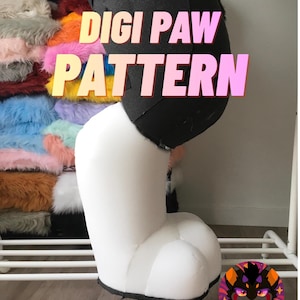 May include: A white and black Digi Paw pattern, with the text "DIGI PAW PATTERN" in a gradient pink and yellow font. A pile of colorful faux fur is visible in the background. A cartoon logo is in the bottom right corner.