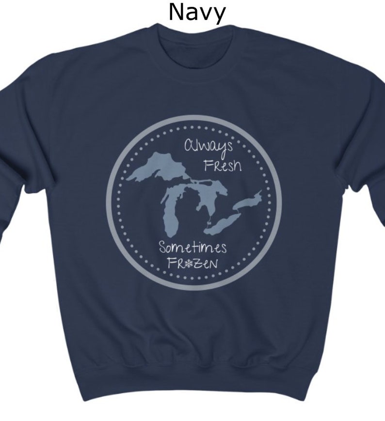 May include: Navy blue sweatshirt with a graphic of the Great Lakes. The graphic says "Always Fresh Sometimes Frozen" with a snowflake in the word "Frozen".