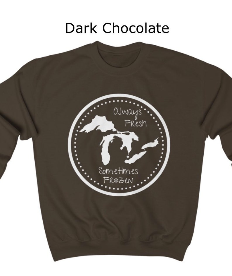 May include: Dark chocolate sweatshirt with a white graphic of the Great Lakes. The graphic says "Always Fresh Sometimes Frozen" with a snowflake.