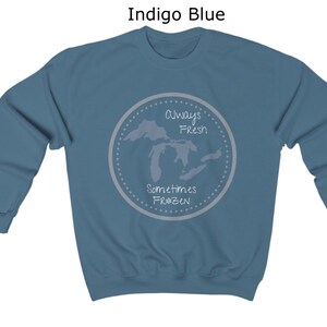 May include: Indigo blue sweatshirt with a white graphic of the Great Lakes. The graphic says "Always Fresh Sometimes Frozen".