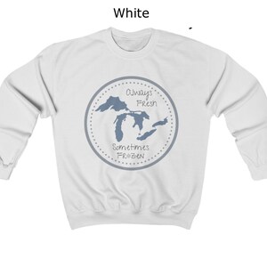 May include: White sweatshirt with a blue graphic of the Great Lakes. The graphic has the text "Always Fresh Sometimes Frozen" in a circle.
