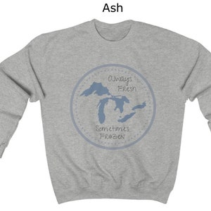 May include: A gray sweatshirt with a blue outline of the Great Lakes and the text "Always Fresh Sometimes Frozen" in a circle.