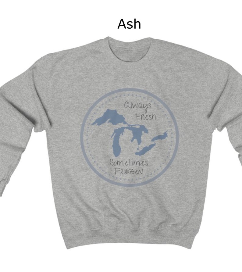 May include: A gray sweatshirt with a blue outline of the Great Lakes and the text "Always Fresh Sometimes Frozen" in a circle.