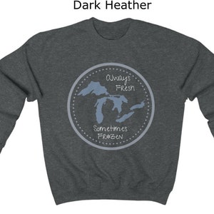 May include: Dark heather grey sweatshirt with a graphic of the Great Lakes. The graphic is a circle with the text "Always Fresh Sometimes Frozen" and a snowflake.