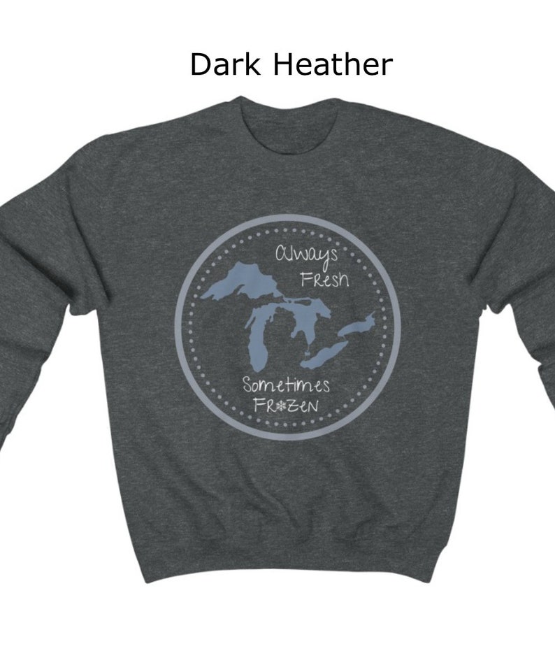 May include: Dark heather grey sweatshirt with a graphic of the Great Lakes. The graphic is a circle with the text "Always Fresh Sometimes Frozen" and a snowflake.