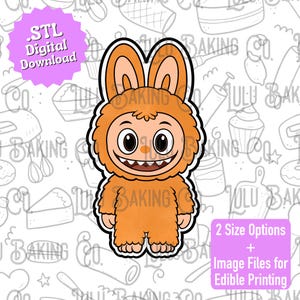 May include: An orange cartoon monster cookie cutter with a smiling face, large eyes, and a furry body. The image includes text that says '.STL Digital Download' and '2 Size Options + Image Files for Edible Printing'.
