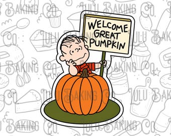 May include: A cartoon character with brown hair wearing a red and black striped shirt sits behind a large orange pumpkin on a green base. The character holds a sign on a stick that reads WELCOME GREAT PUMPKIN in black capital letters.