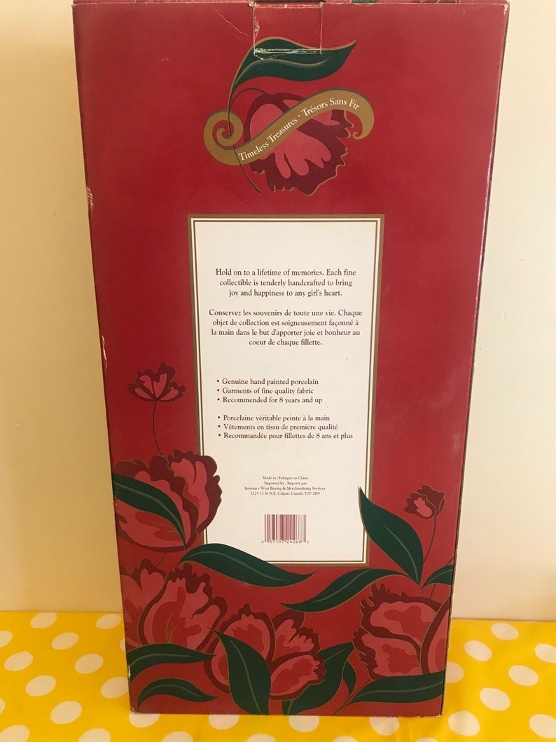 May include: Red box with a floral design and the text "Timeless Treasures Tr&eacute;sors Sans Fir". The box contains a porcelain doll collectible. The text on the box reads "Hold on to a lifetime of memories. Each fine collectible is tenderly handcrafted to bring joy and happiness to any girl's heart."