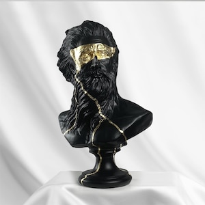 Puede incluir: Busto de escultura de un hombre con barba en negro y dorado. El busto est&aacute; agrietado y tiene detalles dorados.
