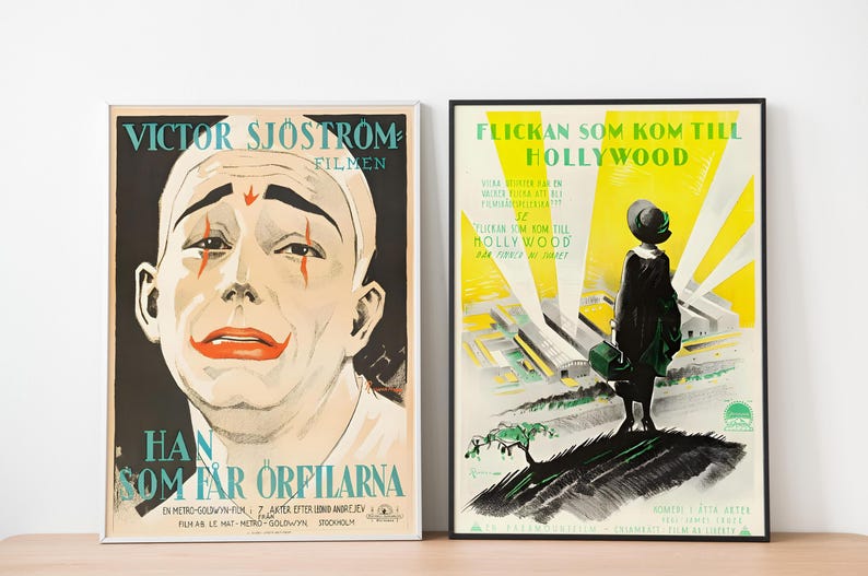 May include: Two vintage movie posters in black frames. The poster on the left features a black and white image of a man with clown makeup and the text "VICTOR SJ&Ouml;STROM FILMEN HAN SOM F&Aring;R ORFILARNA". The poster on the right features a yellow background with a black and white image of a woman in a dress and the text "FLICKAN SOM KOM TILL HOLLYWOOD".