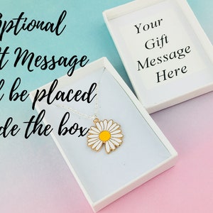 May include: A white gift box containing a daisy charm necklace. The box has a blank card inside that says "Your Gift Message Here".