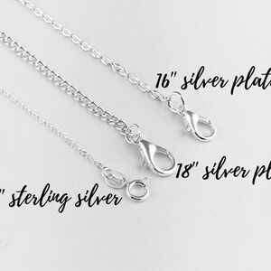 May include: Three silver chains, one sterling silver and two silver plated, with lobster clasps. The chains are 18 inches long, with the silver plated chains also available in 16 inches.