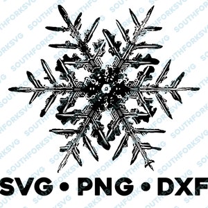 May include: Black and white silhouette of a snowflake with intricate details. The snowflake is centered on a white background. The text "SVG.PNG.DXF" is below the snowflake.