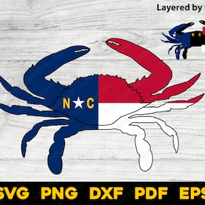 May include: A blue, red, and white crab design with the letters "NC" and a star. The crab is split in half, with the left side blue and the right side red and white. The image also includes the text "Layered by Color" and "SVG PNG DXF PDF EPS".