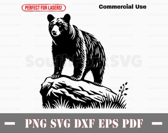 May include: Black and white silhouette of a bear standing on a rock with grass and leaves. The bear is facing the left side of the image.