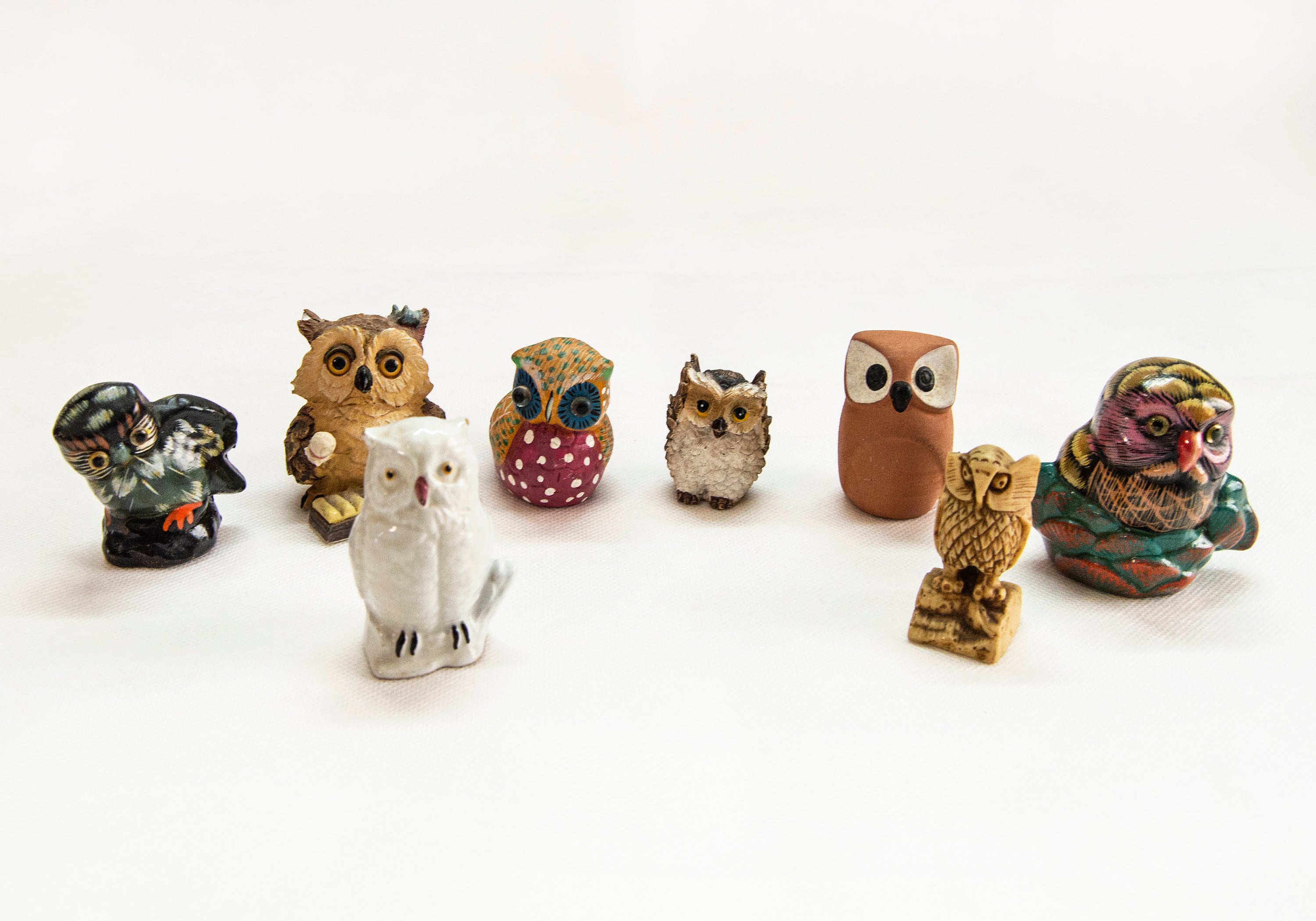 Set of 8 owl figurines. Owls