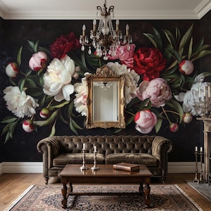 May include: A tufted brown leather sofa sits before a wall mural of large white, pink, and red peonies on a black background. A gold-framed mirror hangs above the sofa, centred beneath a crystal chandelier. A wooden coffee table holds two candles.