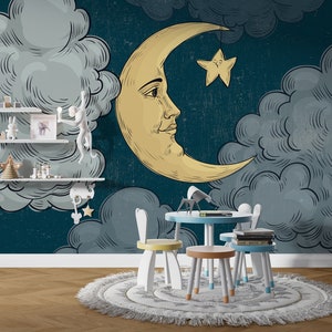 May include: A whimsical children's room featuring a mural with a crescent moon, star, and fluffy clouds. The room includes a small table and chairs, shelves with toys, and a patterned rug on a wooden floor. The color palette is primarily blue, yellow, and white.