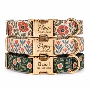 May include: Three pet collars stacked vertically, each featuring a gold-tone metal buckle engraved with a name and phone number. The top collar has a red floral pattern, the middle has a blue and red tulip print, and the bottom is dark green with small flowers.