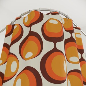 May include: A shower curtain with a retro pattern of orange, brown, and white circles. The circles are arranged in a repeating pattern and have a slightly textured look.
