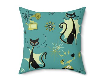 May include: A teal blue throw pillow with a retro design featuring black cats, gold stars, and a vintage phone. The cats have yellow eyes and are outlined in white.