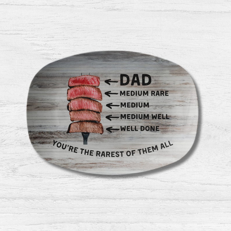 May include: A wooden oval serving platter with a graphic of a steak and a scale showing different levels of doneness. The text reads "Dad You're the rarest of them all".