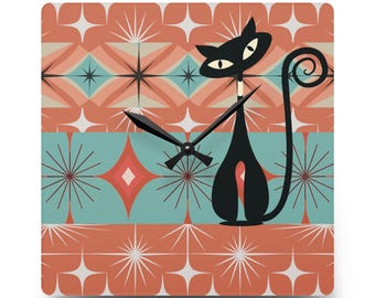 May include: A black cat with a curled tail stands in front of a retro-style clock face with a teal, orange, and white geometric pattern. The clock hands are black.