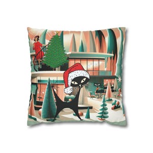 May include: Square throw pillow with a mid-century modern Christmas scene. A black cat wearing a Santa hat is in the foreground. A woman in a red dress stands on a balcony. The background features a house, Christmas trees, and a winter landscape.