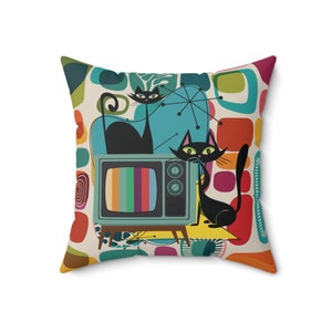 May include: A retro-style throw pillow featuring a colorful abstract design with two black cats sitting in front of a vintage television set.