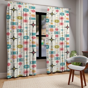 May include: Two floor-length curtains hanging from a metal rod, featuring an off-white background with a repeating pattern of teal rectangles, pink starbursts, yellow circles, and black four-pointed stars arranged in a grid-like layout.