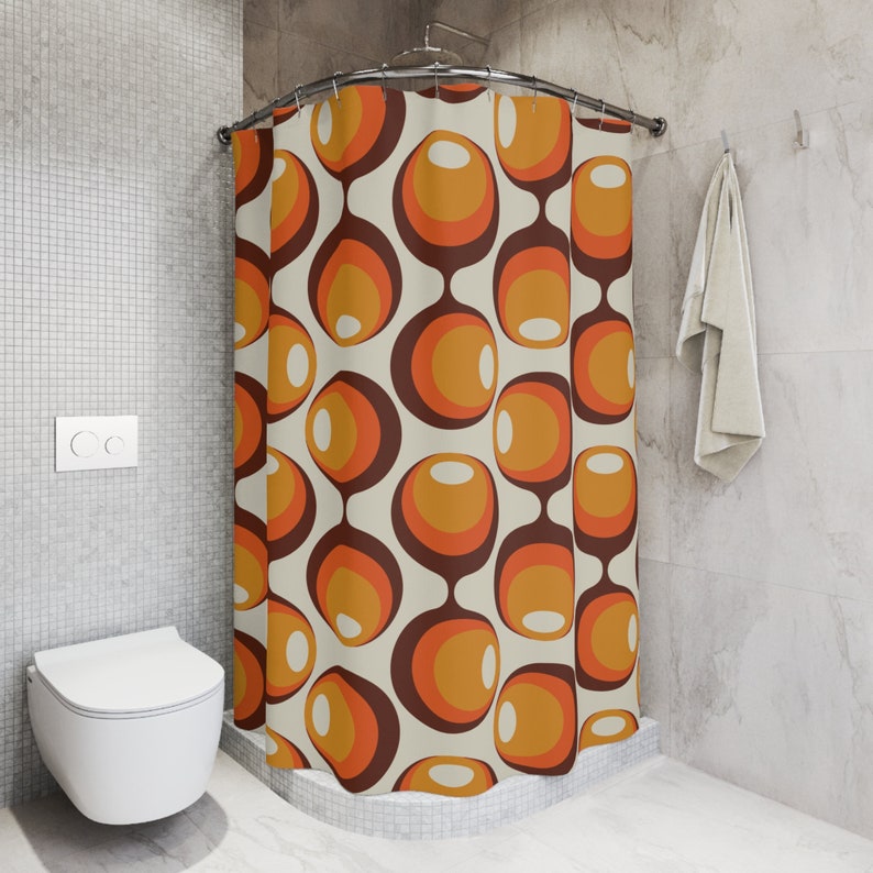 May include: A shower curtain with a retro pattern of orange, brown, and white circles. The curtain is hanging in a bathroom with a white toilet and tiled walls.