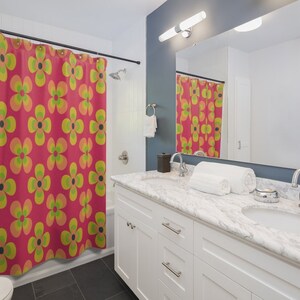 May include: A bathroom with a white vanity and a shower curtain with a retro floral pattern in shades of pink, yellow, and green.