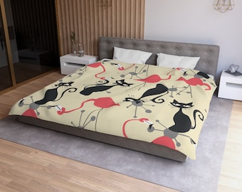 May include: A beige duvet cover with a repeating pattern of black cats and pink flamingos. The cats are stylized and the flamingos have long legs and necks. The background is a light beige color.