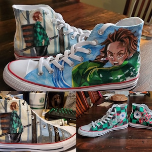 May include: Custom-painted high-top canvas sneakers featuring anime-style artwork. One pair depicts a character with brown hair and a green and black checkered pattern. The other pair shows a character with brown hair and a green checkered pattern.