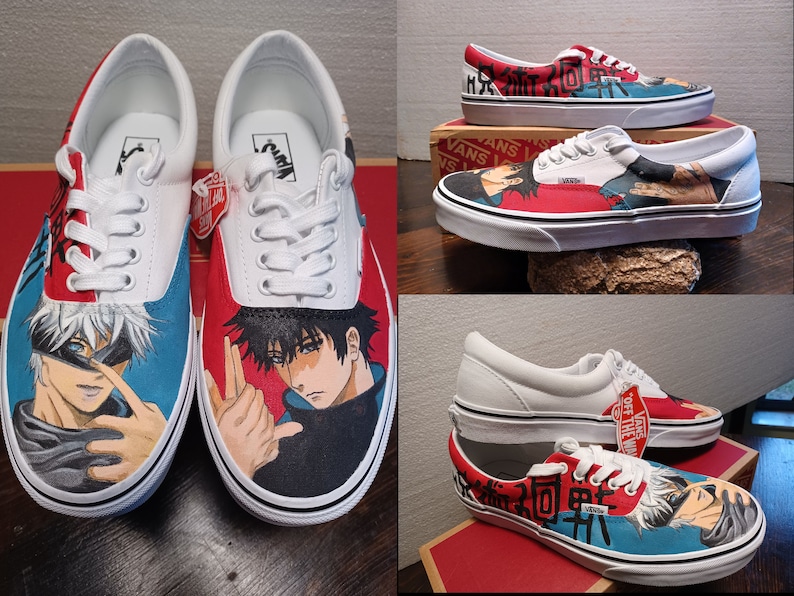 May include: White Vans Era sneakers customized with anime character artwork. The shoes feature red and blue accents, with detailed illustrations of anime characters on the sides. The laces are white, and the soles are white with a black stripe.