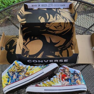 May include: A set of three ceramic mugs with a speckled, matte finish. The mugs are in shades of cream, light brown, and dark brown. Each mug has a simple, minimalist design and a rounded handle.