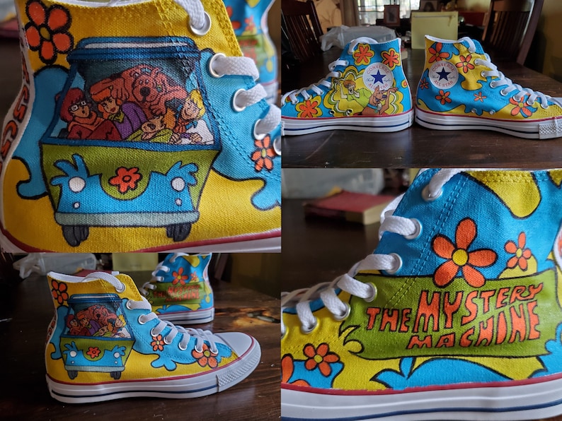 May include: Custom-painted high-top canvas sneakers featuring the Mystery Machine from Scooby-Doo. The shoes have a yellow base with blue accents and orange flower details. The Mystery Machine van is depicted on the side, and the phrase "The Mystery Machine" is displayed.