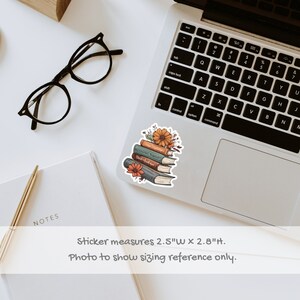 May include: A sticker featuring a stack of five books with floral accents. The books are illustrated with a vintage aesthetic and have titles like "World's Greatest Stories" and "The Adventures of Sherlock Holmes". The sticker measures 2.5 inches wide by 2.8 inches tall.