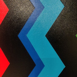 Może przedstawiać: Abstrakcyjne geometryczne malowidło z czarnym tłem i wzorem w kształcie niebieskich, turkusowych i czerwonych szevron&oacute;w.
