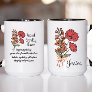 May include: Two white ceramic mugs with black rims. One mug features a floral bouquet with red poppies and orange gladiolus, and the text "August Birthday Flowers". The other mug has the same floral bouquet and the name "Jessica".