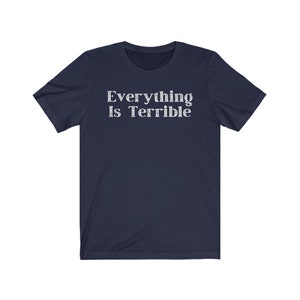 May include: Navy blue short-sleeved t-shirt with the text "Everything Is Terrible" printed in white.