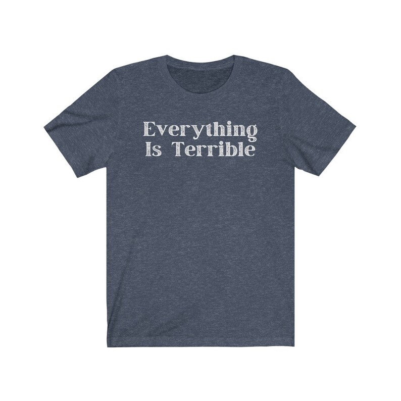 May include: A dark blue t-shirt with the text "Everything Is Terrible" printed in white.