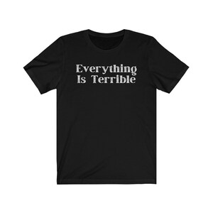 May include: Black short-sleeved t-shirt with the text "Everything Is Terrible" printed in white.