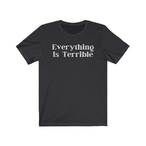 May include: A black short-sleeved t-shirt with the text "Everything Is Terrible" printed in white on the front.