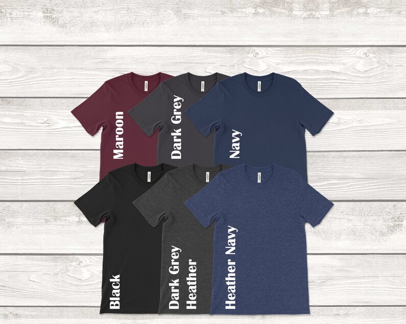 Peut inclure: Six t-shirts de diff&eacute;rentes couleurs, dont le marron, le gris fonc&eacute;, le bleu marine, le noir, le gris chin&eacute; et le bleu marine chin&eacute;. Chaque t-shirt porte une &eacute;tiquette de couleur blanche sur le c&ocirc;t&eacute; indiquant la couleur.